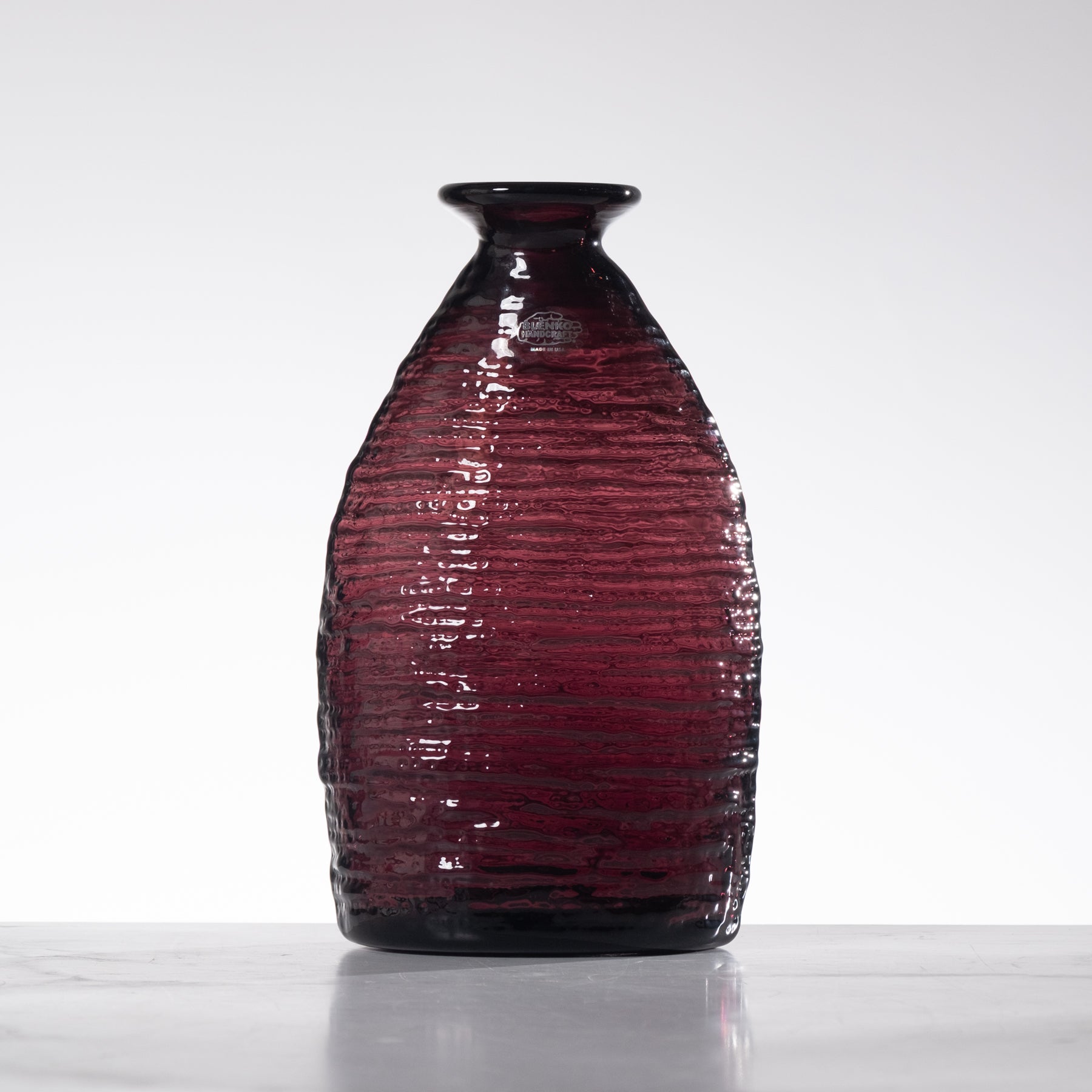 Glossy purple vase on a white background