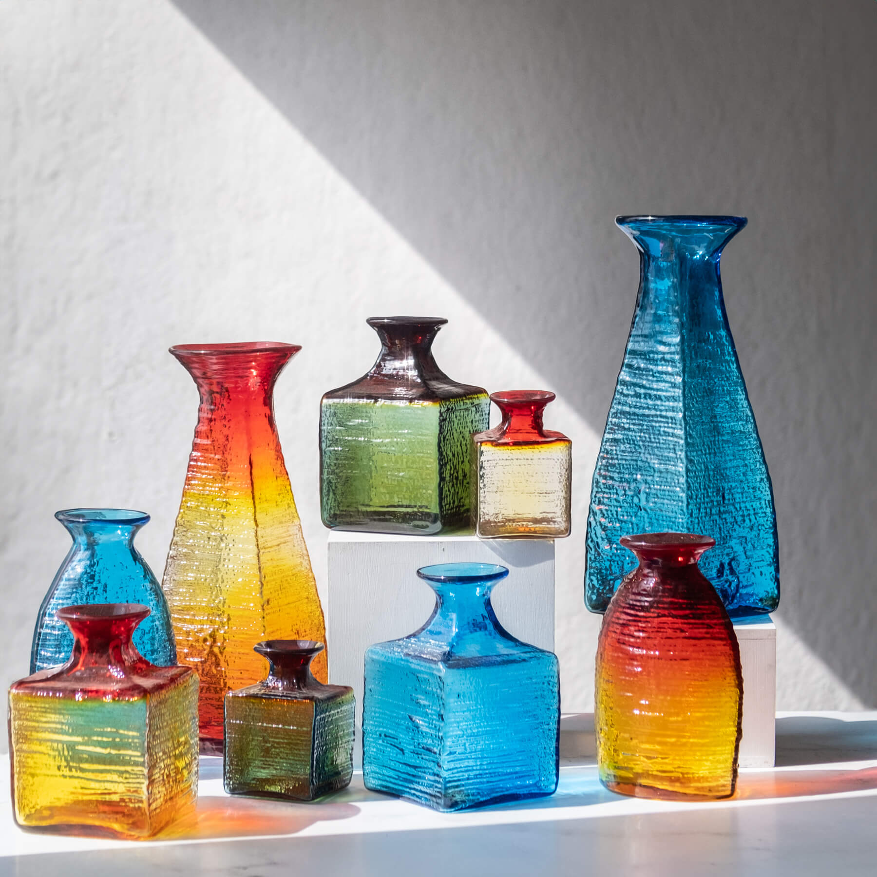 A group of Blenko Strata vases in sunlight.