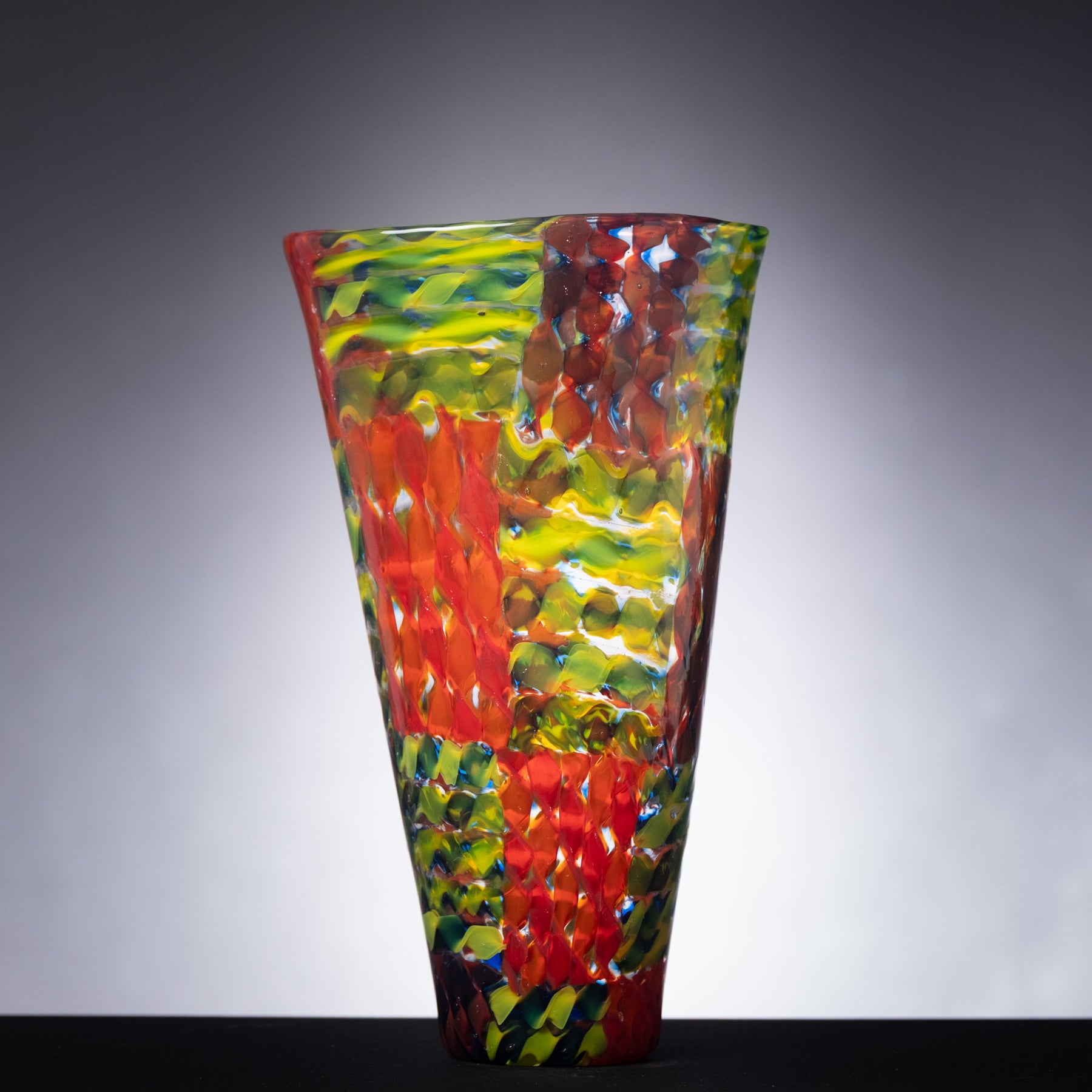 Colorful glass vase on a gray background