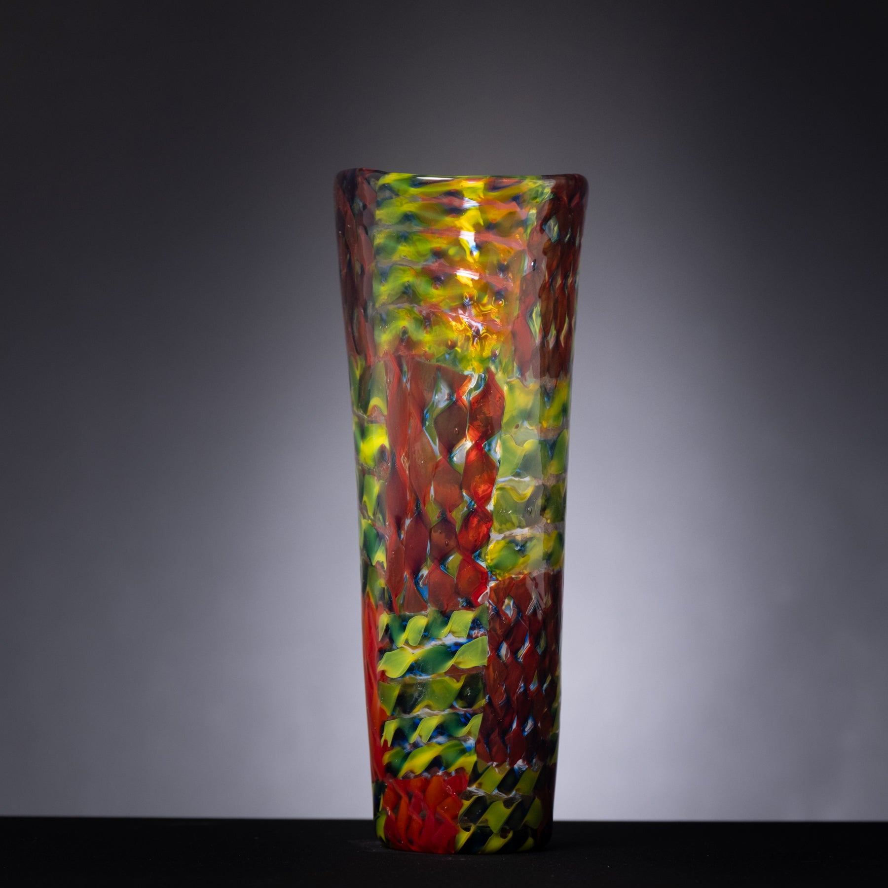 Colorful glass vase on a gray background