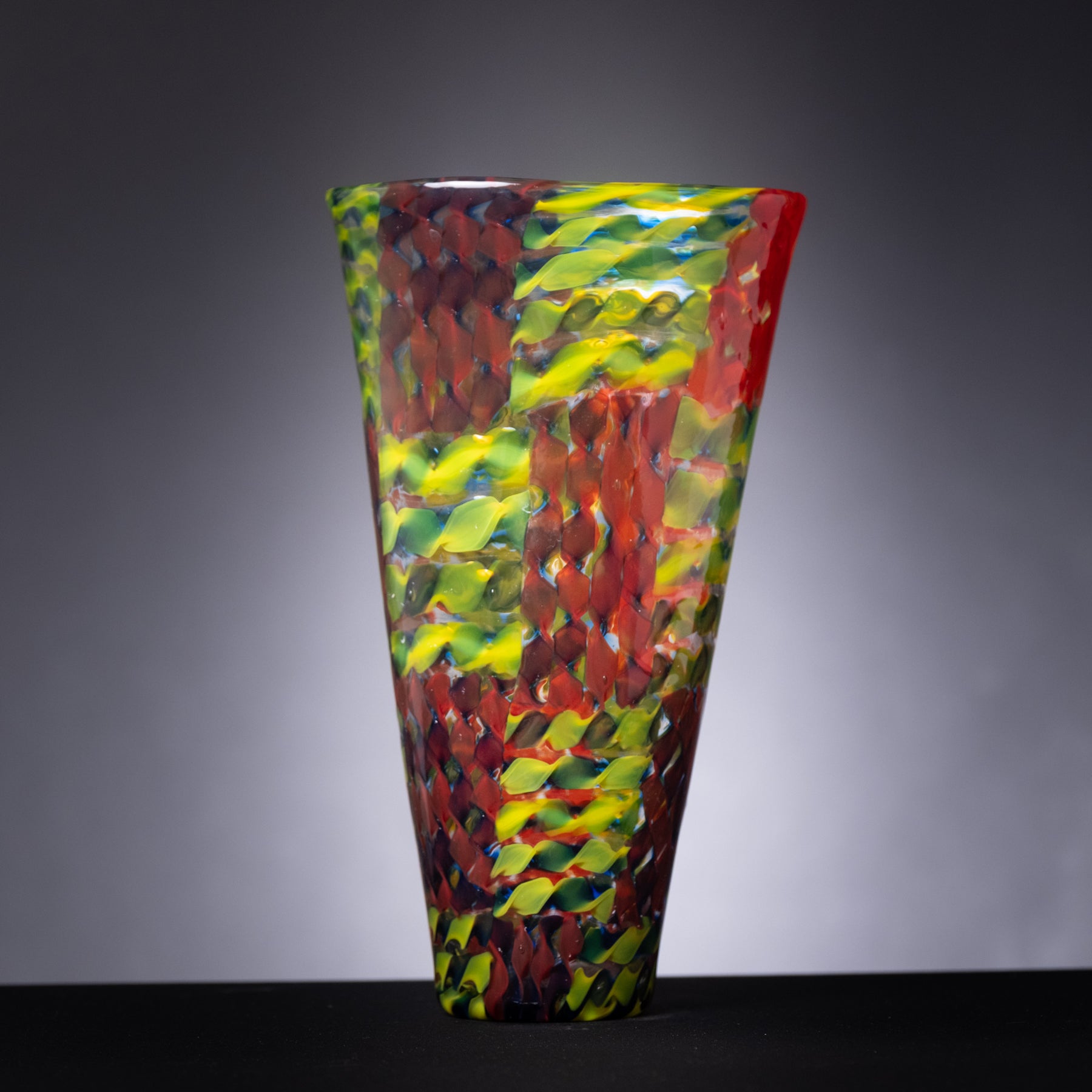 Colorful glass vase on a gray background