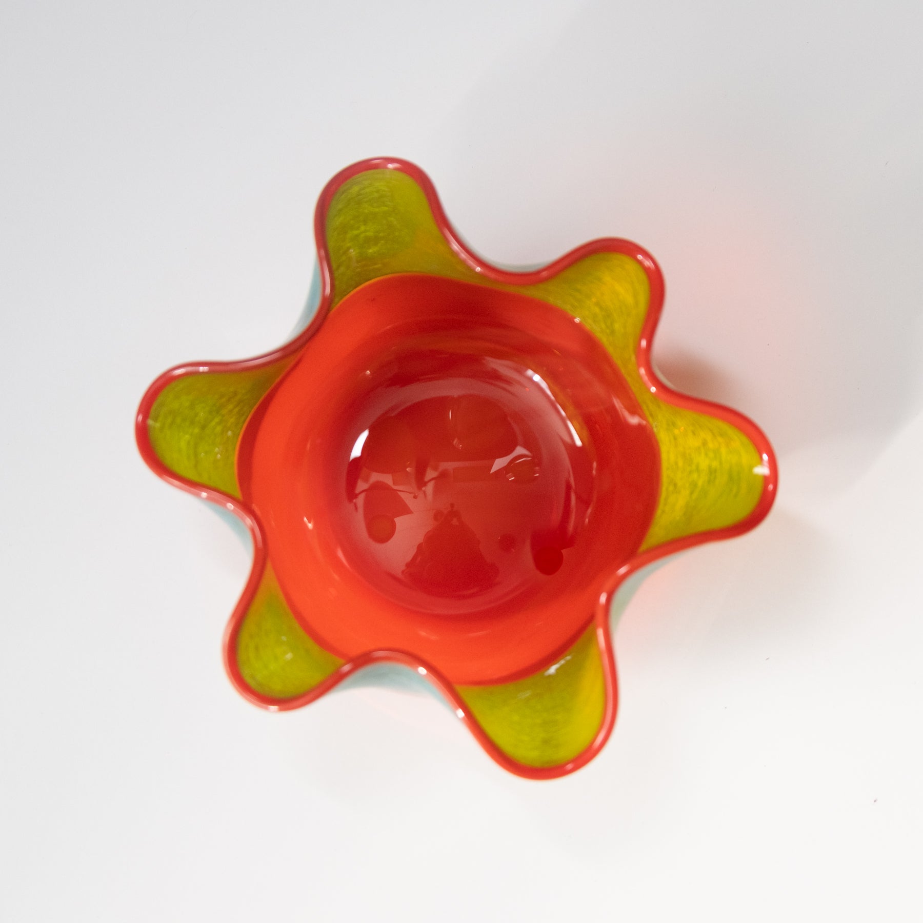 Decorative bowl with red and green design on a white background