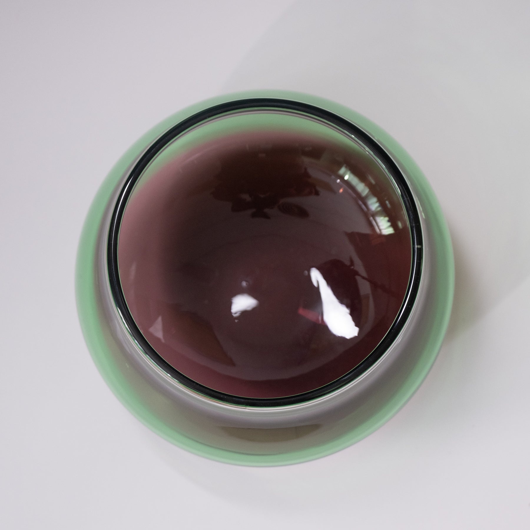 Round container with a reflective surface on a white background
