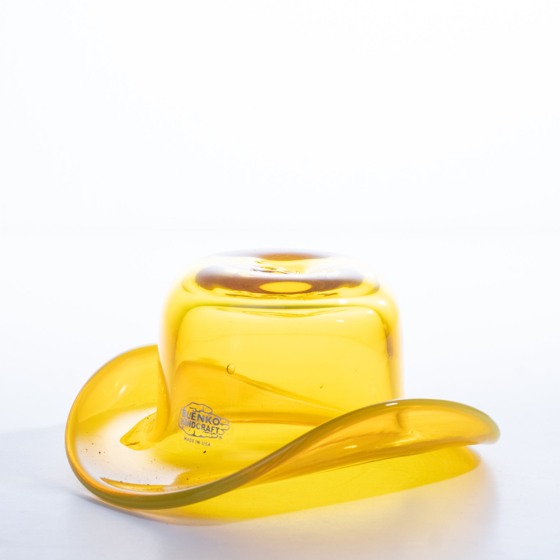 Yellow glass container with a lid on a white background