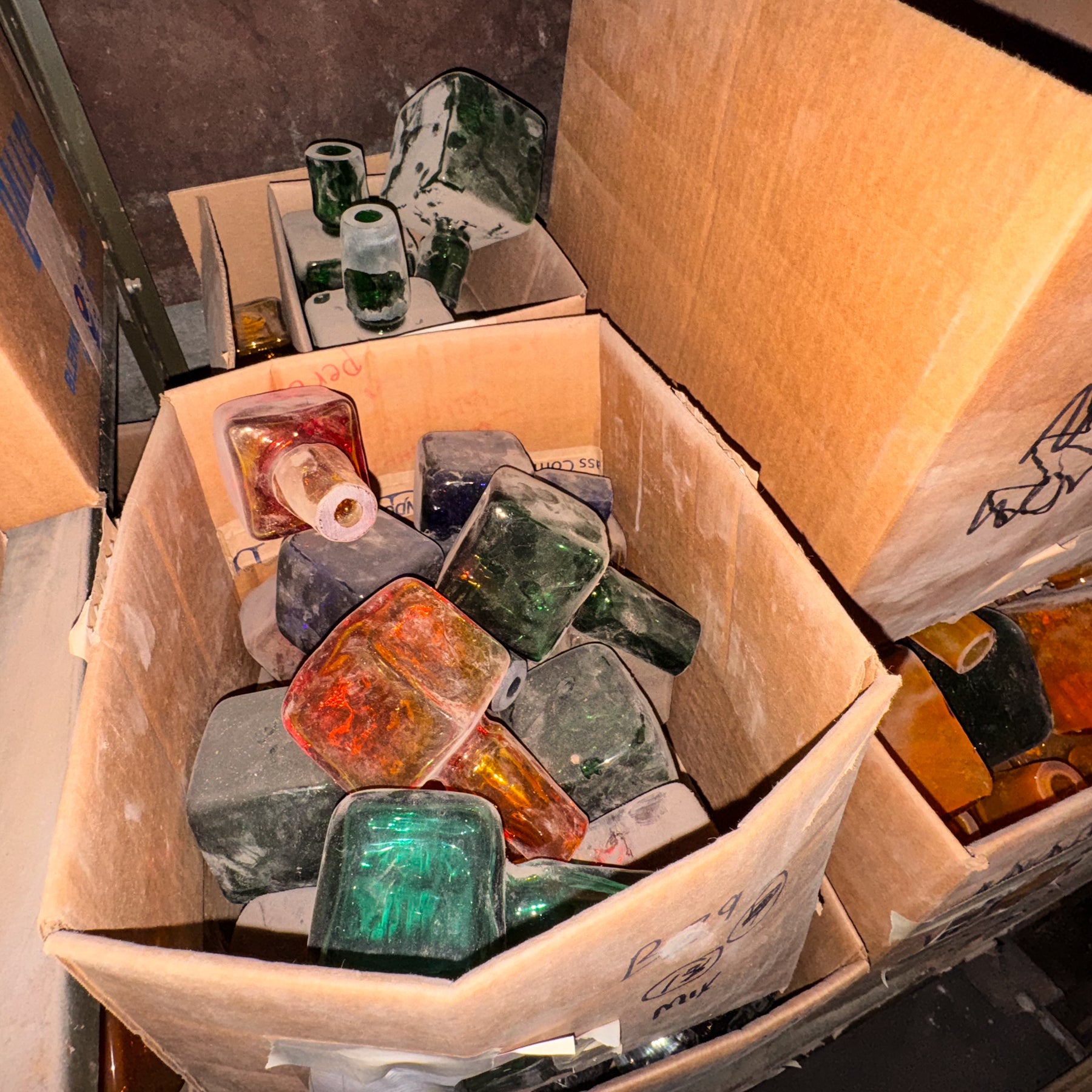 Box filled with colorful stones or crystals on a dark background