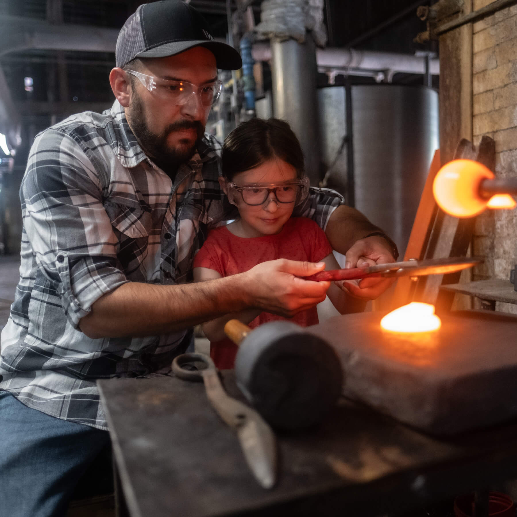 girl and her father making blue sun-catcher with a chicken on it