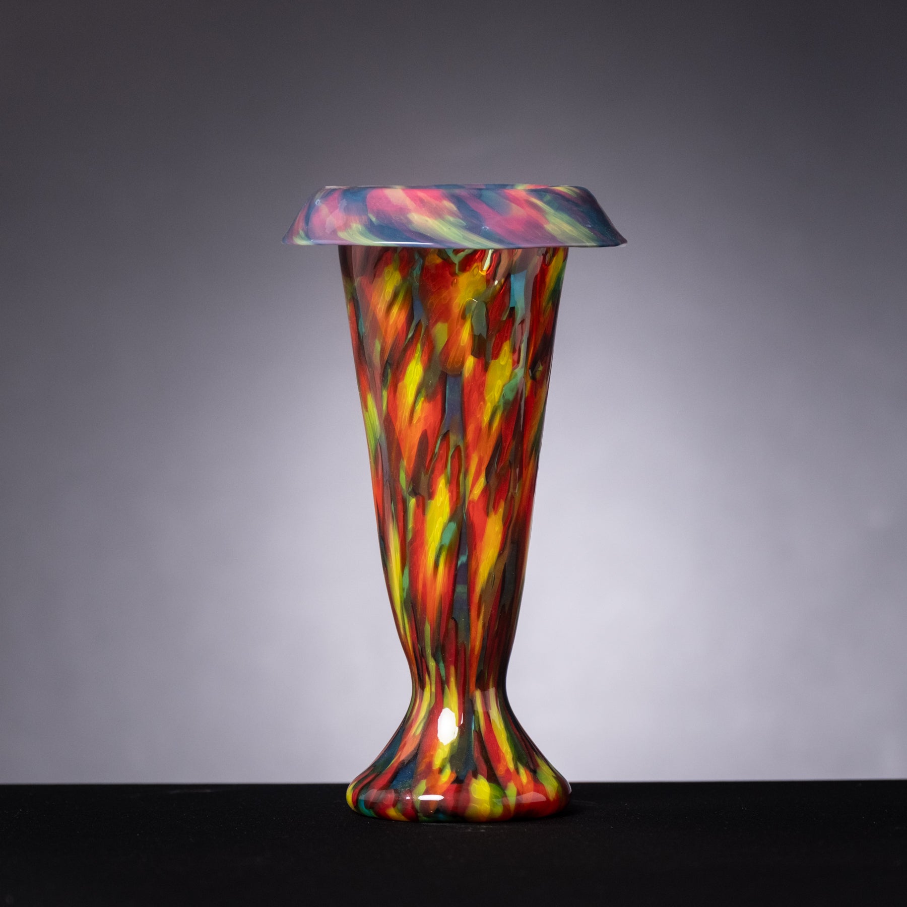 Colorful glass vase on a gray background