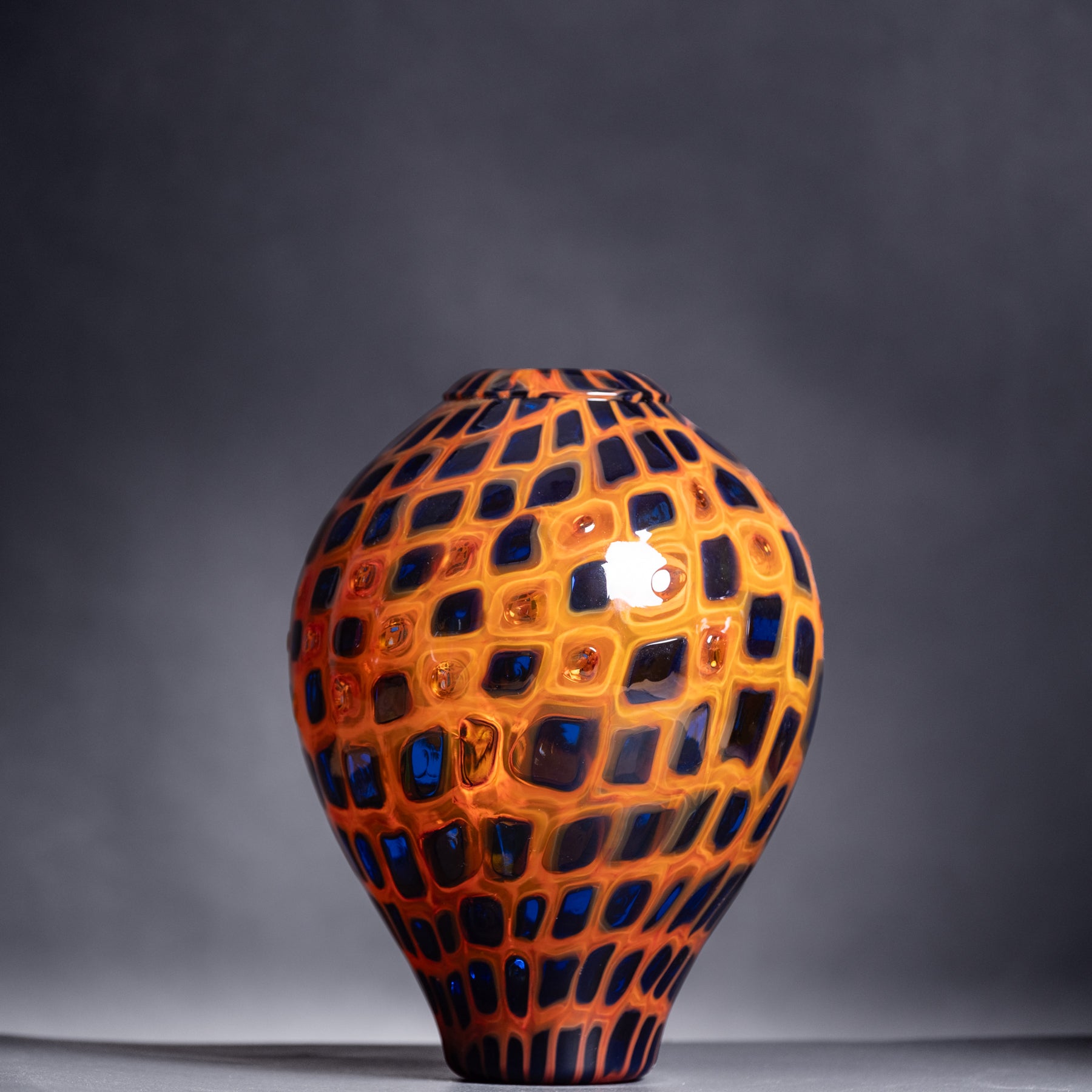 Decorative vase with a geometric pattern on a gray background