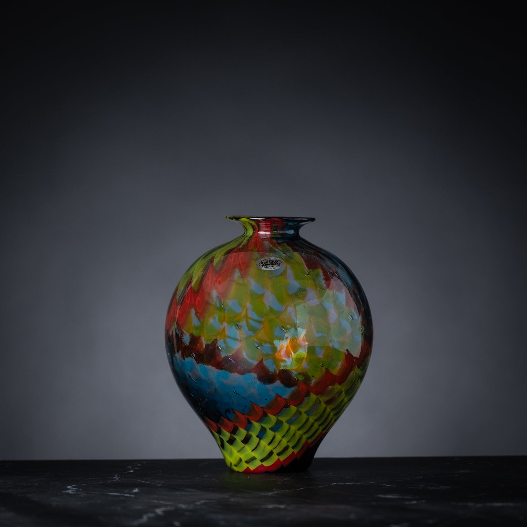 Colorful vase with scaled design.