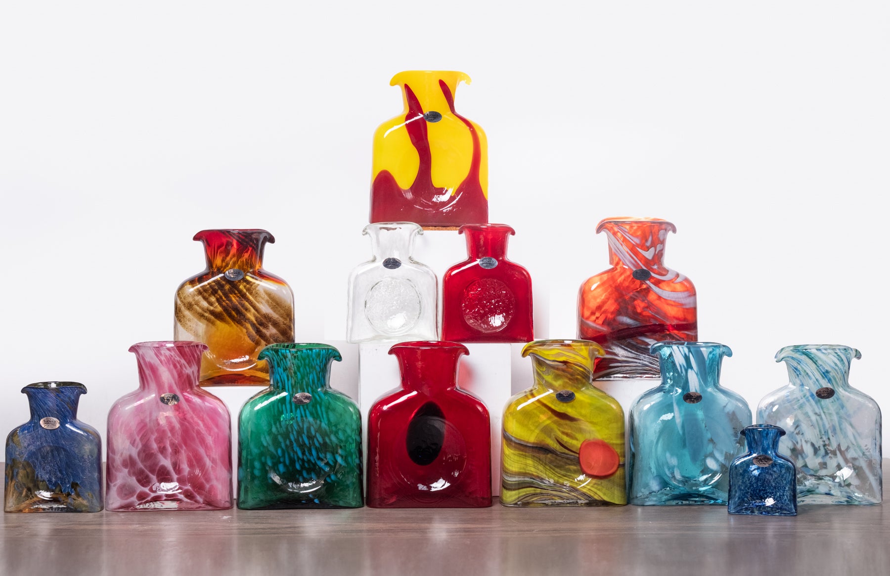 Collection of colorful glass vases on a white background