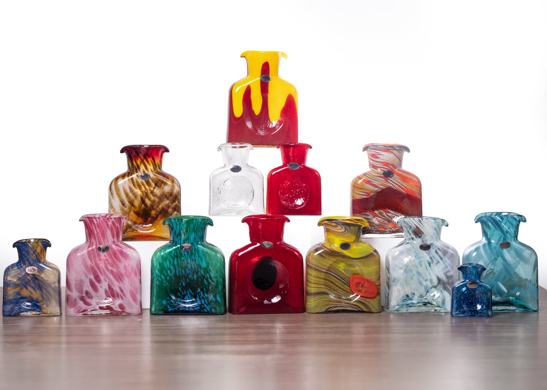 Collection of colorful glass vases on a white background