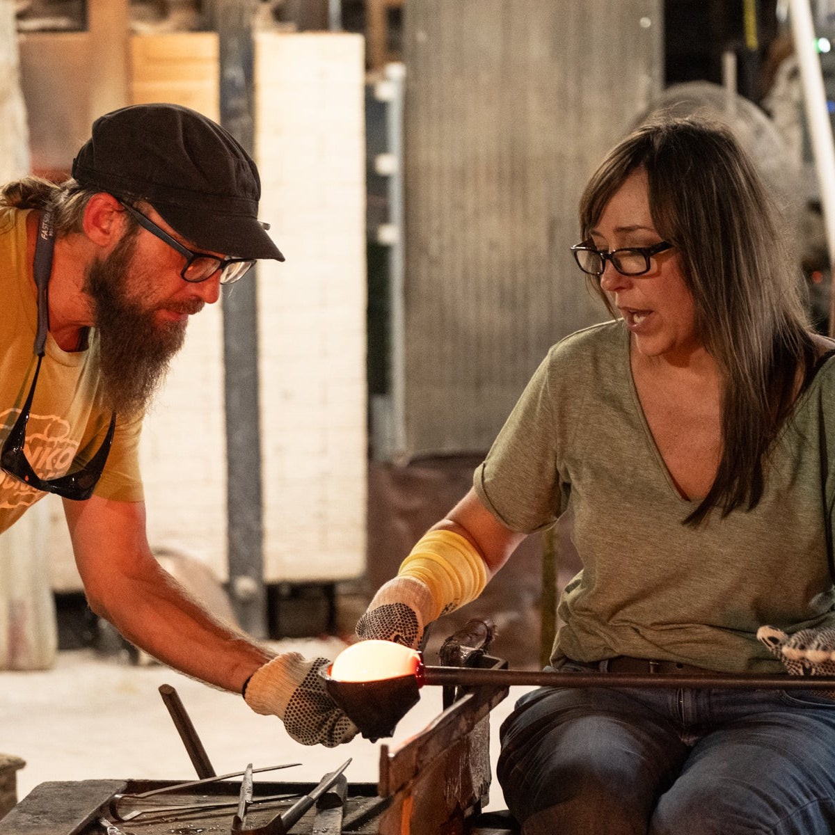 Two people working together in a workshop setting.